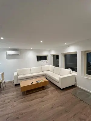 a living room with a white couch and a coffee table at Gjestehus i Trondheim, under VM 2025 in Trondheim