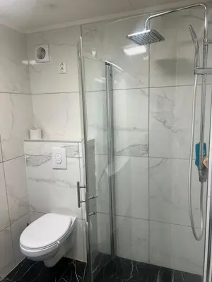 a bathroom with a shower with a toilet and a glass shower stall at Gjestehus i Trondheim, under VM 2025 in Trondheim