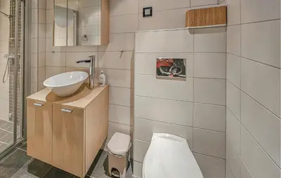 a bathroom with a toilet and a sink at 5 Bedroom Cozy Apartment In Ustaoset in Ustaoset