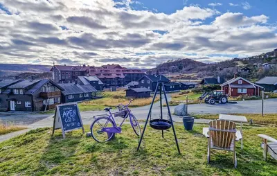 a bike on display next to a sign and chairs at 5 Bedroom Cozy Apartment In Ustaoset in Ustaoset