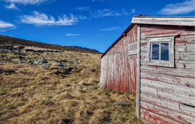 an old red barn sitting in a field at 5 Bedroom Cozy Apartment In Ustaoset in Ustaoset