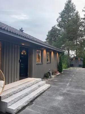 a house with a front porch and stairs to it at Ringåsen in Berg
