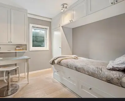 a bedroom with a bed and a desk and a table at Ringåsen in Berg