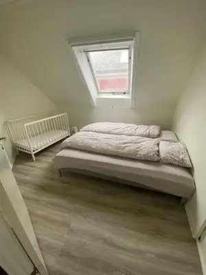 a bedroom with a bed and a window at Central appartment with a nice view in Bergen