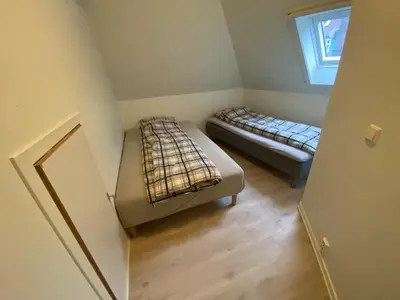 a small room with two beds and a window at Central appartment with a nice view in Bergen
