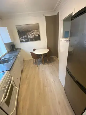 a small kitchen with a table and a refrigerator at Central appartment with a nice view in Bergen