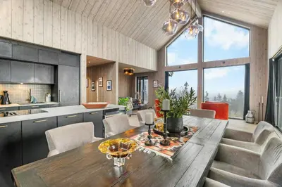 a kitchen and dining room with a wooden table and chairs at Family Cabin At The Foot Of Gaustatoppen in Rjukan