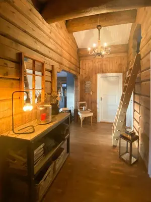 a kitchen with wooden walls and a staircase in a room at Charming Log Cabin In Jøldalen in Rennebu