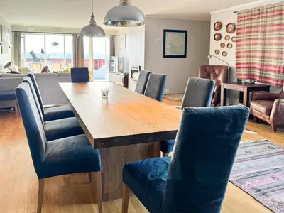 a dining room with a wooden table and blue chairs at Big And Modern Apartment At Beitostølen in Beitostøl