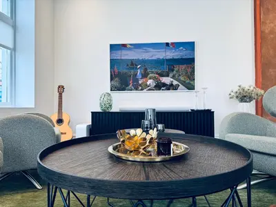 a table with a plate of food on top of it at Elegant Three-Bedroom Apartment with Stunning Sea Views - Limited availability - Secure your booking for Summer in Ålesund