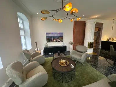 a living room with chairs and a table and a couch at Elegant Three-Bedroom Apartment with Stunning Sea Views - Limited availability - Secure your booking for Summer in Ålesund