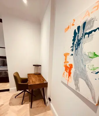 a room with a desk and a painting on the wall at Elegant Three-Bedroom Apartment with Stunning Sea Views - Limited availability - Secure your booking for Summer in Ålesund