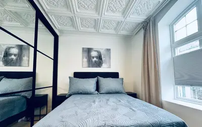 a bedroom with a bed and a coffered ceiling at Elegant Three-Bedroom Apartment with Stunning Sea Views - Limited availability - Secure your booking for Summer in Ålesund