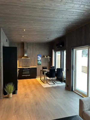 a living room with a table and a dining room at Lovely apartment in beautiful Loen in Loen