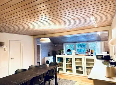 a kitchen with a long table and some chairs at 5 room apartment for Ski-World Championship in Trondheim