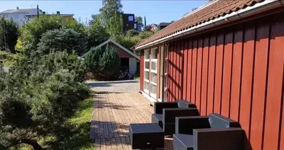 a group of chairs sitting outside of a building at 5 room apartment for Ski-World Championship in Trondheim