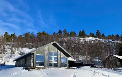 a house in the snow with a mountain at Stunning Home In Bjorli With Wifi in Bjorli
