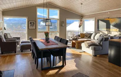 a living room with a table and a couch at Stunning Home In Bjorli With Wifi in Bjorli