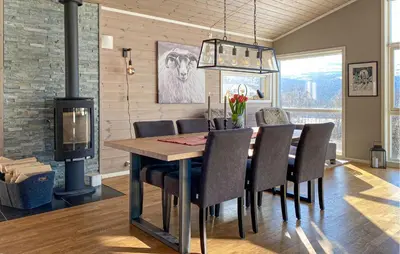 a dining room with a table and a wood stove at Stunning Home In Bjorli With Wifi in Bjorli