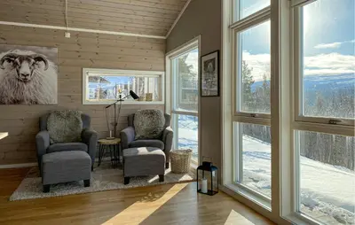 a living room with two chairs and a picture of a sheep at Stunning Home In Bjorli With Wifi in Bjorli