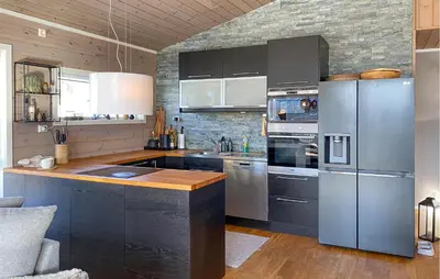 a kitchen with black cabinets and stainless steel appliances at Stunning Home In Bjorli With Wifi in Bjorli