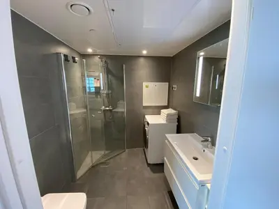 a bathroom with a shower and a sink and a toilet at Apartment in Trondheim, Tiller in Trondheim