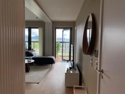 a living room with a mirror and a couch at Apartment in Trondheim, Tiller in Trondheim
