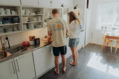 a man and a woman standing in a kitchen at Villa Fjellheim in Luster