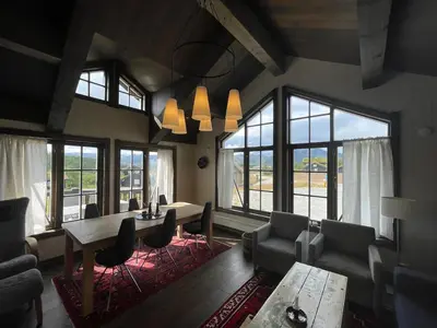 a living room with a table and chairs and windows at Mountain Retreat Near Hiking And Skiing in Beitostøl