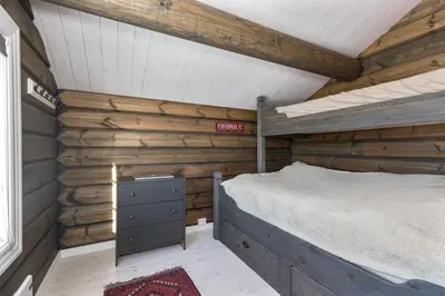a bedroom with a bed in a log cabin at New Timber Lodge With Stunning Views And Comfort in Beitostøl