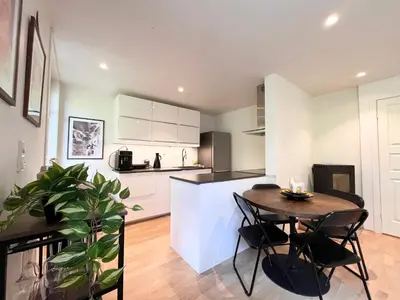 a kitchen and dining room with a table and chairs at Urban retreat, traditional wooden house in Bergen in Bergen
