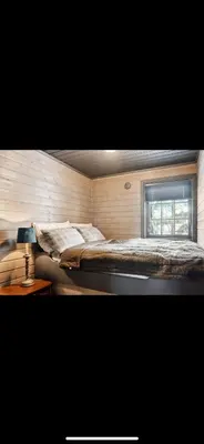 a large bed in a room with a window at Bjorli Mountain Cabin in Bjorli