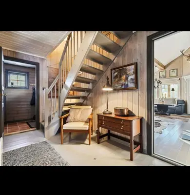 a stairway with a desk and a chair in a room at Bjorli Mountain Cabin in Bjorli