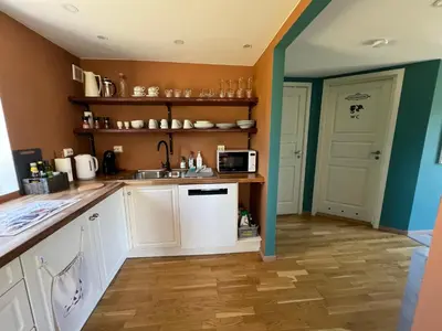 a kitchen with a sink and a microwave at Sokkelleilighet i enebolig i Ålesund nær stranden in Ålesund
