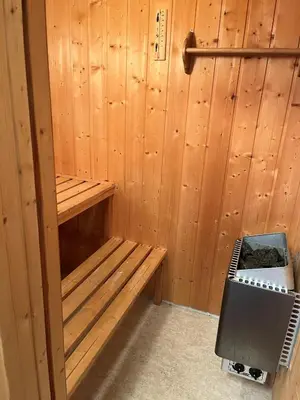 a sauna with a bench in a wooden wall at Cozy Cabin Hovden Fjellpark 71 in Hovden
