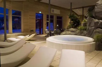 a large room with a hot tub in a building at Cozy Cabin Hovden Fjellpark 71 in Hovden