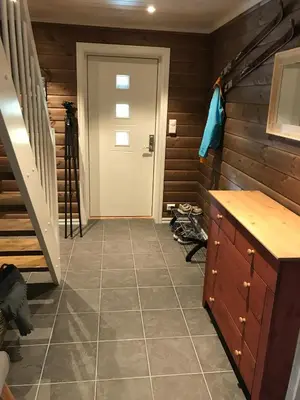 a hallway with a white door and a staircase at New Cozy Cabin By Ski Trails And Nature Paths in Beitostøl