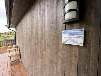 a sign on the side of a wooden building at New Cozy Cabin By Ski Trails And Nature Paths in Beitostøl