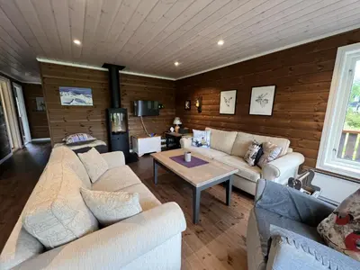 a living room with couches and a table at New Cozy Cabin By Ski Trails And Nature Paths in Beitostøl