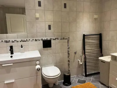 a bathroom with a toilet and a sink at Koselig rekkehus til leie under ski VM i Trondheim in Trondheim