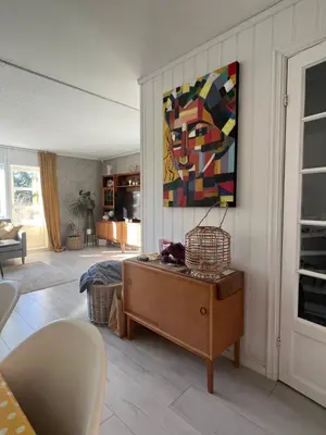 a living room with a painting on the wall at Koselig rekkehus til leie under ski VM i Trondheim in Trondheim