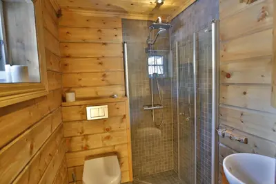 a bathroom with a shower and a toilet at Relaxing Getaway With Sauna And Terrace in Beitostøl