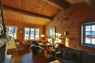 a living room with wooden walls and a wooden ceiling at Relaxing Getaway With Sauna And Terrace in Beitostøl