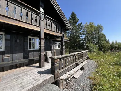 a wooden building with a bench on the side of it at Relaxing Getaway With Sauna And Terrace in Beitostøl