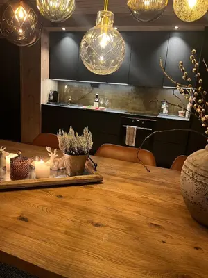a dining room with a wooden table and lights at Stylish apartment in Myrkdalen in Vossestrand