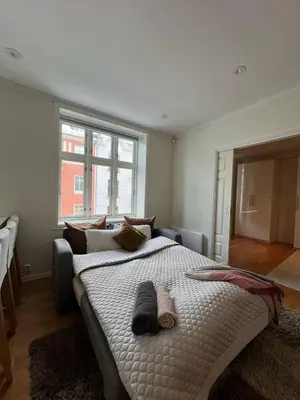 a bedroom with a large bed with two slippers on it at Apartment near City Center in Trondheim