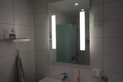 a bathroom with a sink and a mirror at Solrik leilighet på Byåsen in Trondheim