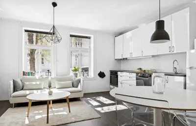 a kitchen and living room with a couch and a table at Modern apartment close to the city center in Trondheim