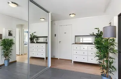 a room with white dressers and a mirror at 4 roms leilighet ved Fosshaugane Campus in Sogndal