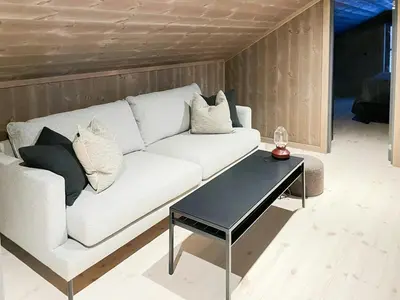 a living room with a white couch and a table at Mountain Cabin At Hardangervidda in Uvdal